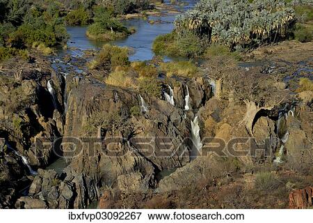 Stock Photo - "Epupa Falls, waterfalls of the Kunene River on the Namibian-Angolan border, Kunene Region, Namibia, Africa". Fotosearch