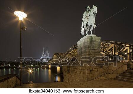 "Equestrian statue of Wilhelm I, in back the illuminated Cologne Cathedral and Hohenzollern Bridge at night with Rhine, Deutz, Cologne, North Rhine-Westphalia, Germany, Europe" View Large Photo Image Stock Image - "Equestrian statue of Wilhelm I, in back the illuminated Cologne Cathedral and Hohenzollern Bridge at night with Rhine, Deutz, Cologne, North Rhine-Westphalia, Germany, Europe". Fotosearch