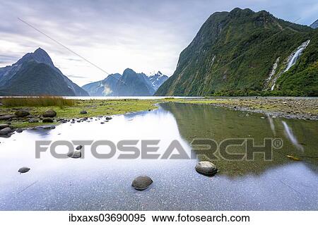 Stock Photography - "Evening at Milford Sound with Mitre Peak, 1683m, Cascade Peak, 1209m, and the Bowen Falls, 162m, Fiordland National Park, Southland Region, New Zealand, Oceania". Fotosearch