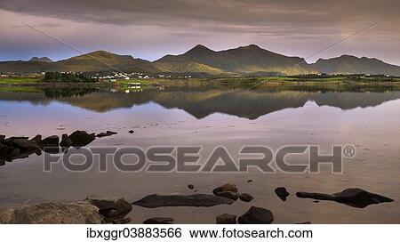 Stock Photograph - "Evening light at Offersoystraumen near Valberget with a view towards Leknes and Guratinden Mountain, Vestvagoya, Lofoten, Nordland, Norway, Europe". Fotosearch