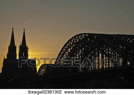 Stock Image - "Evening mood, Cologne Cathedral and Hohenzollernbrucke bridge, Cologne, North Rhine-Westphalia, Germany, Europe, PublicGround, Europe". Fotosearch
