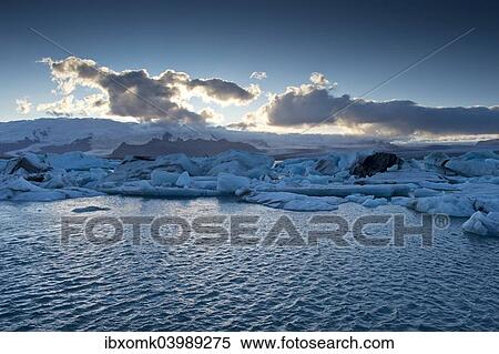 "Evening mood, sun behind clouds, glacier lagoon of Jokulsarlon, Southern Region, Iceland, Europe" View Large Photo Image Stock Photography - "Evening mood, sun behind clouds, glacier lagoon of Jokulsarlon, Southern Region, Iceland, Europe". Fotosearch