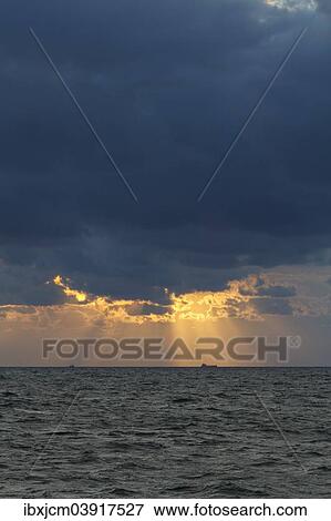Stock Photo - "Evening sky over the Baltic Sea, Wustrow, Bay of Mecklenburg, Mecklenburg-Western Pomerania, Germany, Europe". Fotosearch