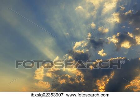 "Evening sky, sun rays breaking through clouds" View Large Photo Image Stock Photo - "Evening sky, sun rays breaking through clouds". Fotosearch