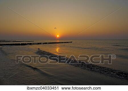Stock Image - "Evening sun on the Baltic Sea, in front groin with seagull, Ahrenshoop, Darss, Mecklenburg-Western Pomerania, Germany, Europe". Fotosearch
