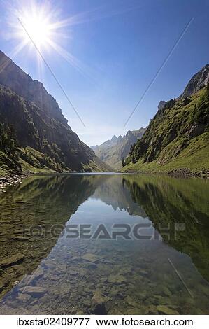 "Faehlensee lake with the sun in Alpstein Range, Appenzell, Switzerland, Europe" View Large Photo Image Stock Photo - "Faehlensee lake with the sun in Alpstein Range, Appenzell, Switzerland, Europe". Fotosearch