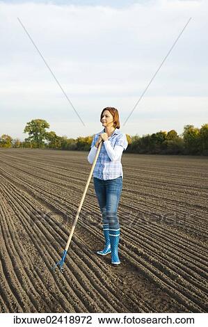 Farmer working in her field View Large Photo Image Stock Image - Farmer working in her field. Fotosearch