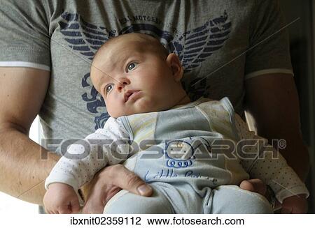 Father holding a baby View Large Photo Image Stock Image - Father holding a baby. Fotosearch