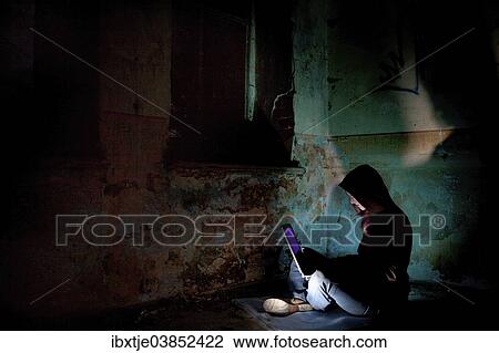 "Female computer hacker sitting with a laptop in the dark, in an old building" View Large Photo Image Stock Image - "Female computer hacker sitting with a laptop in the dark, in an old building". Fotosearch