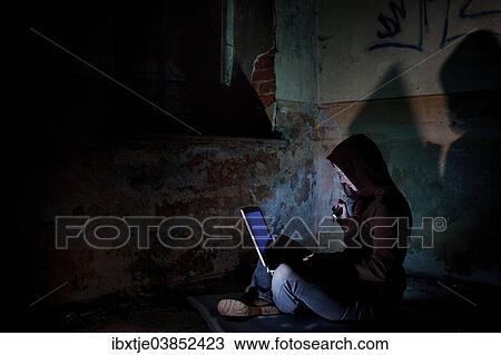"Female computer hacker sitting with a laptop in the dark, in an old building" View Large Photo Image Stock Image - "Female computer hacker sitting with a laptop in the dark, in an old building". Fotosearch