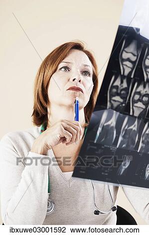 "Female doctor looking at an X-ray, Mannheim, Baden-Wurttemberg, Germany, Europe" View Large Photo Image Stock Image - "Female doctor looking at an X-ray, Mannheim, Baden-Wurttemberg, Germany, Europe". Fotosearch