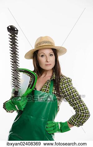 Female gardener holding a hedge trimmer View Large Photo Image Stock Photo - Female gardener holding a hedge trimmer. Fotosearch