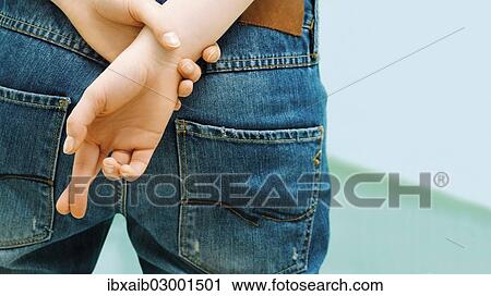 "Female person, with crossed fingers behind her back, superstition" View Large Photo Image Stock Image - "Female person, with crossed fingers behind her back, superstition". Fotosearch