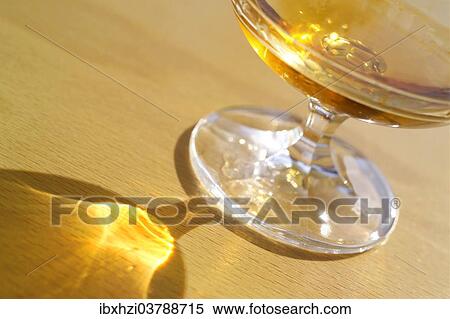 Filled Cognac glass with reflexes on table top View Large Photo Image Stock Photography - Filled Cognac glass with reflexes on table top. Fotosearch
