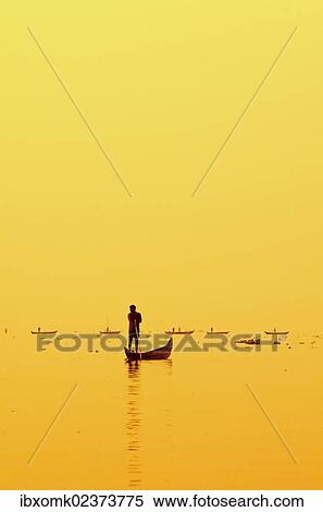 Stock Photography - "Fisherman fishing on Lake Vembanad at sunrise, Kerala, southern India, India, Asia". Fotosearch