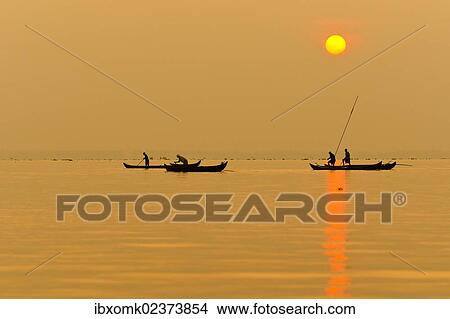 Picture - "Fishermen fishing on Lake Vembanad at sunrise, Kerala, southern India, India, Asia". Fotosearch