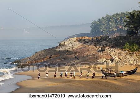 Stock Photo - "Fishermen pulling in a net, beach south of Kovalam, Vizhinjam in the distance, Malabar Coast, Malabar, Kerala, southern India, India, Asia". Fotosearch
