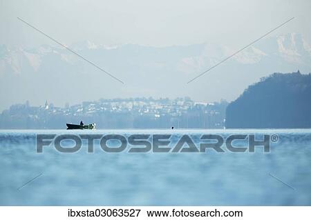 "Fishing boat on Lake Constance with the Alps at back, Langenargen, Baden-Wurttemberg, Germany, Europe" View Large Photo Image Stock Photo - "Fishing boat on Lake Constance with the Alps at back, Langenargen, Baden-Wurttemberg, Germany, Europe". Fotosearch