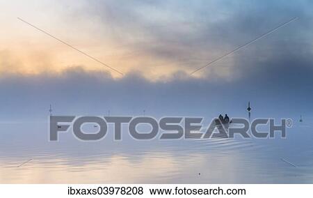 Stock Photo - "Fishing boat on the mist-shrouded Untersee, Radolfzell, Baden-Wurttemberg, Germany, Europe". Fotosearch