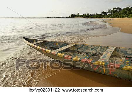 Stock Image - "Fishing boat, pirogue, on the beach in Kribi, Cameroon, Central Africa, Africa". Fotosearch