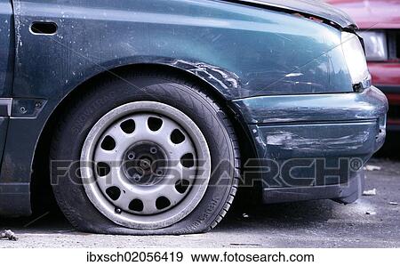 Flat tyre on a car involved in an accident View Large Photo Image Stock Photo - Flat tyre on a car involved in an accident. Fotosearch