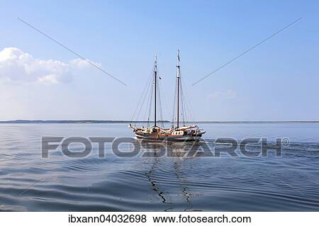 "Flatboat, sailing ship in the Barther Bodden lagoon, Zingst, Fischland-Darss-Zingst, Mecklenburg-Western Pomerania, Germany, Europe" View Large Photo Image Stock Photo - "Flatboat, sailing ship in the Barther Bodden lagoon, Zingst, Fischland-Darss-Zingst, Mecklenburg-Western Pomerania, Germany, Europe". Fotosearch