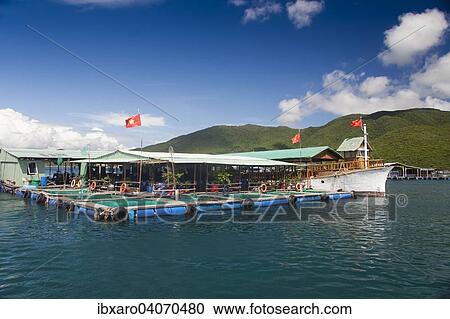Stock Image - "Floating houses off the island of Ho Ca Tri Nguyen, Nha Trang Bay, South China Sea, Vietnam, Asia". Fotosearch