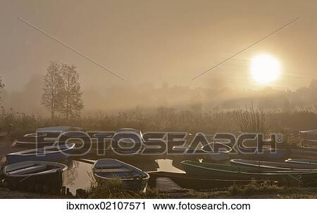 Stock Image - "Fog at Staffelsee Lake with Woerth Island near Seehausen, Murnau, Upper Bavaria, Bavaria, Germany, Europe". Fotosearch