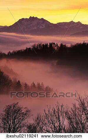 "Foggy mood in the evening light with view on Mt. Pilatus, Zug, Switzerland, Europe" View Large Photo Image Stock Image - "Foggy mood in the evening light with view on Mt. Pilatus, Zug, Switzerland, Europe". Fotosearch