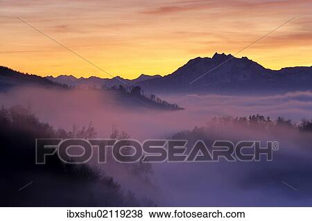 "Foggy mood in the evening light with view on Mt. Pilatus, Zug, Switzerland, Europe" View Large Photo Image Stock Photo - "Foggy mood in the evening light with view on Mt. Pilatus, Zug, Switzerland, Europe". Fotosearch