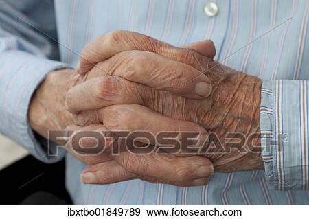 Stock Photo - "Folded hands of an old man, in prayer, nursing home, retirement home, Berlin, Germany, Europe". Fotosearch