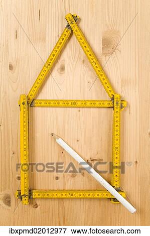Folding carpenter's ruler folded in the form of a house beside a pencil View Large Photo Image Stock Photo - Folding carpenter's ruler folded in the form of a house beside a pencil. Fotosearch
