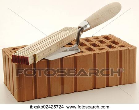 Folding rule and smoothing trowel on a red brick View Large Photo Image Picture - Folding rule and smoothing trowel on a red brick. Fotosearch