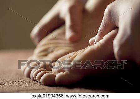 Foot massage for relaxation View Large Photo Image Stock Photograph - Foot massage for relaxation. Fotosearch