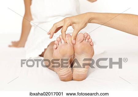 "Foot massage, woman's feet being massaged" View Large Photo Image Stock Image - "Foot massage, woman's feet being massaged". Fotosearch
