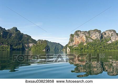 Stock Photo - "Forested karst limestone mountains reflected in the water, Rachabrapha reservoir, Chiao Lan Lake, Khao Sok National Park, Surat Thani Province, Southern Thailand, Thailand, Asia". Fotosearch