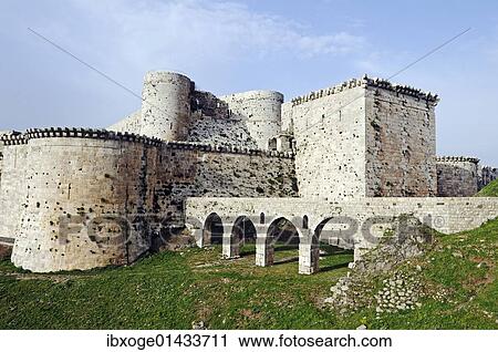 Stock Image - "Fortifications and walls of the castle and fortress Krak des Chevaliers, Qal'at al-ß? ñiß? ún, UNESCO World Heritage Site, built by crusaders, Syria, Middle East, Asia". Fotosearch