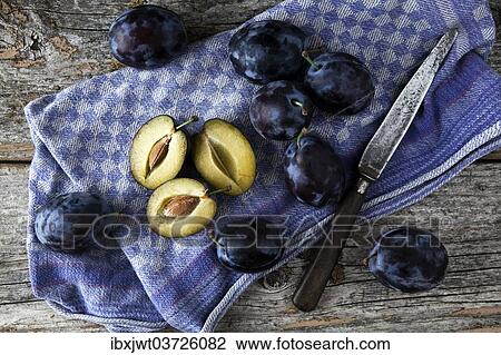 "Fresh plums (Prunus domestica) on a kitchen towel, with a knife" View Large Photo Image Stock Image - "Fresh plums (Prunus domestica) on a kitchen towel, with a knife". Fotosearch