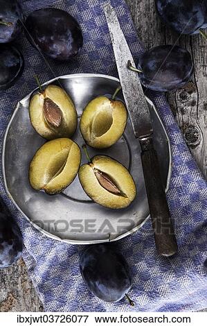 "Fresh plums (Prunus domestica) on a tin plate, with a knife and a kitchen towel" View Large Photo Image Stock Photo - "Fresh plums (Prunus domestica) on a tin plate, with a knife and a kitchen towel". Fotosearch