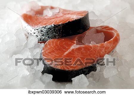 Stock Photograph - Fresh salmon steaks on crushed ice. Fotosearch