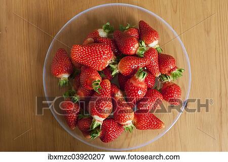 Fresh strawberries on a glass plate on wooden background View Large Photo Image Stock Photo - Fresh strawberries on a glass plate on wooden background. Fotosearch
