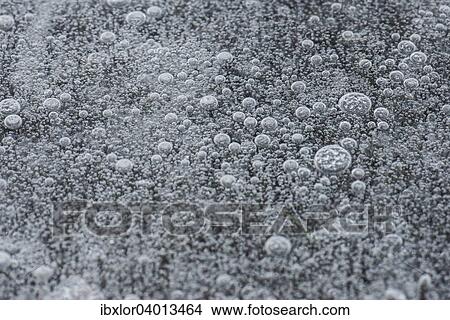 Frozen air bubbles in white ice View Large Photo Image Picture - Frozen air bubbles in white ice. Fotosearch