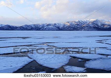 Stock Image - "Frozen Lake Kussharo with ice floes in the front, Akan-Nationalpark, Kawayu Onsen, Hokkaido, Japan, Asia". Fotosearch
