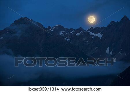 Picture - "Full moon above the Kaunergrat ridge, Kaunertal valley, Tyrol, Austria, Europe". Fotosearch