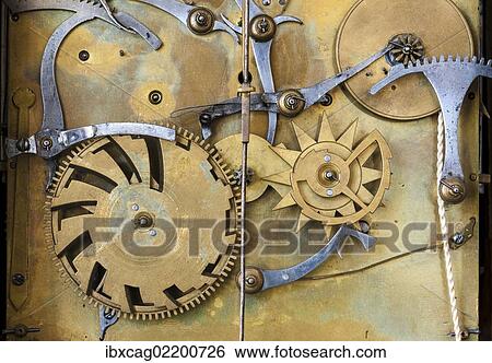 Stock Photograph - "Gears and cogs in the clockwork of a historical pendulum clock, detail, regulator". Fotosearch