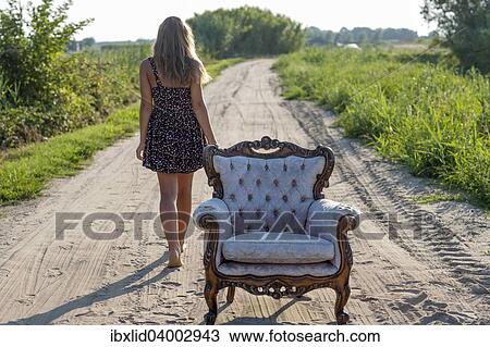 "Girl, 14 years, walking along a track, an old armchair in front" View Large Photo Image Stock Image - "Girl, 14 years, walking along a track, an old armchair in front". Fotosearch