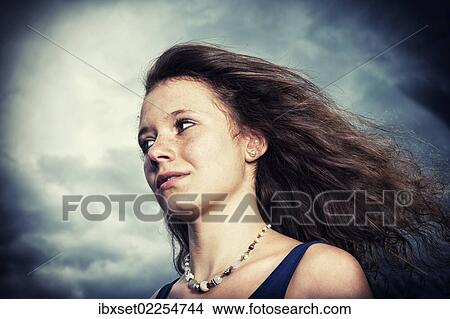 "Girl, 14 years, with long hair in front of a gloomy cloudy sky, portrait" View Large Photo Image Picture - "Girl, 14 years, with long hair in front of a gloomy cloudy sky, portrait". Fotosearch