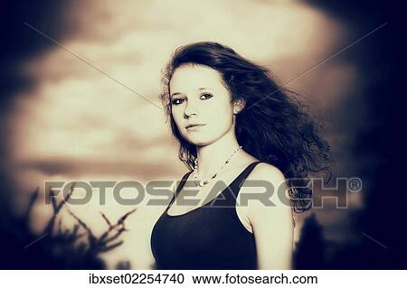 "Girl, 14 years, with long hair in front of a gloomy cloudy sky, portrait" View Large Photo Image Stock Image - "Girl, 14 years, with long hair in front of a gloomy cloudy sky, portrait". Fotosearch