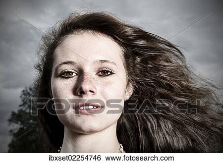 "Girl, 14 years, with long hair in front of a gloomy cloudy sky, portrait" View Large Photo Image Stock Photograph - "Girl, 14 years, with long hair in front of a gloomy cloudy sky, portrait". Fotosearch