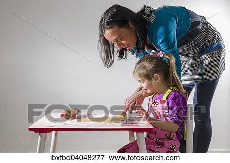 "Girl, 3 years, and her mother, baking Christmas cookies" View Large Photo Image Stock Photo - "Girl, 3 years, and her mother, baking Christmas cookies". Fotosearch